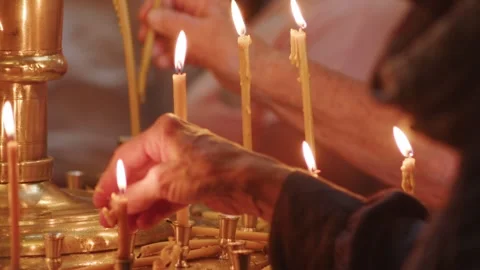 Human palm hands holding burning candle in dark black background. Close up view Stock Footage 253556808
