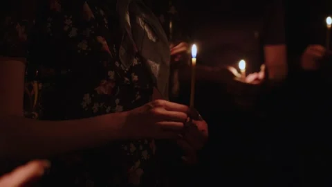 Human palm hands holding burning candle in dark black background. Close up view Stock Footage 253773858