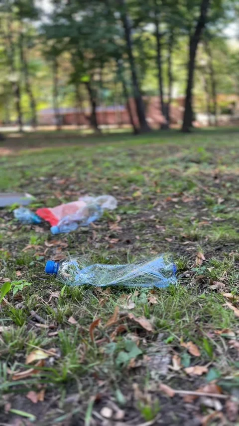 Human polluting forest with plastic waste 動画素材 329319870