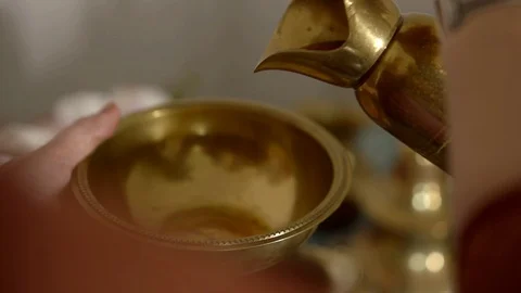Human is pouring decoction of herbs from old traditional oriental teapot in Stock Footage 113567970