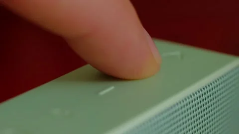 Human pressing on power button to start the electrical computer or speaker Video stock 192803248