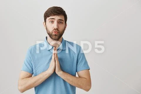Human relationship and body language concept. Guy standing with hands in pray Stock Photos