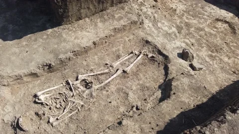 Human remains, bones of skeleton and skulls in the ground tomb. Stock Footage 136720309