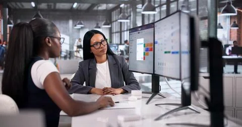 Human Resource Manager Explains Payroll Software To Two Women Colleagues On D Stock Photos
