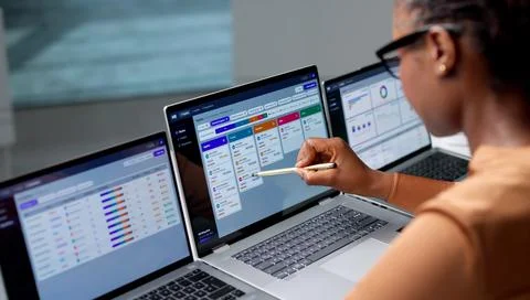Human Resource Manager Reviews Candidate Schedule On Laptop Using Digital Che 写真素材