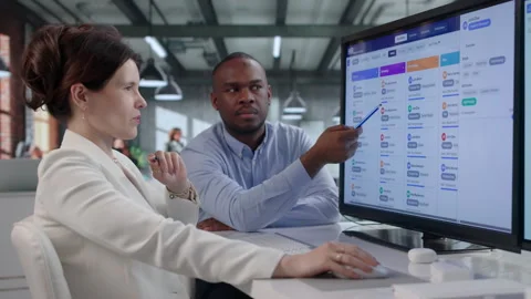 Human Resources Manager And Assistant Reviewing Candidate Profiles Together Stock Footage 343882727