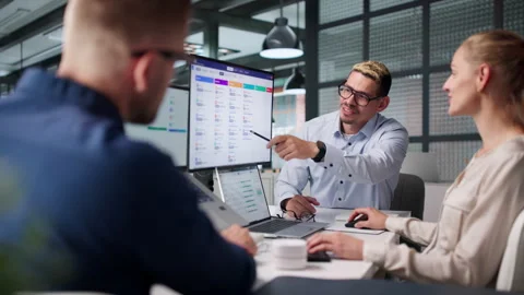 Human Resources Manager And Team Discuss Software On Laptop Stock Footage 338168706