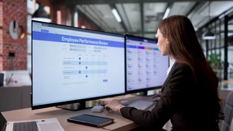 Human Resources Manager Carefully Filling Employee Performance Review Form Stock Footage 335880475