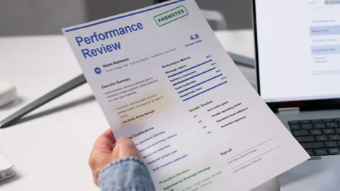 Human Resources Manager Carefully Reviews Employee's Annual Performance Stock Footage 336374489