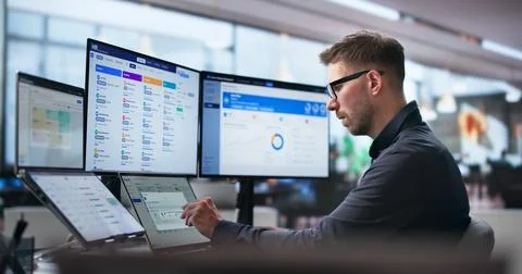 Human Resources Manager Schedules Interviews Using Dual Touchscreen Monitors  Stock Photos