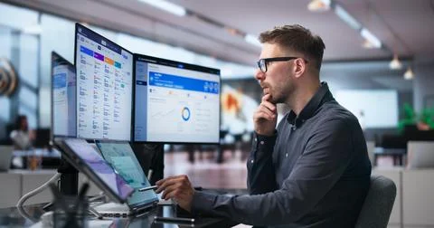 Human Resources Manager Schedules Interviews Using Dual Touchscreen Monitors  Stock Photos