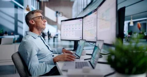 Human Resources Manager Using Laptop To Review Employee Performance Data. Stock Photos