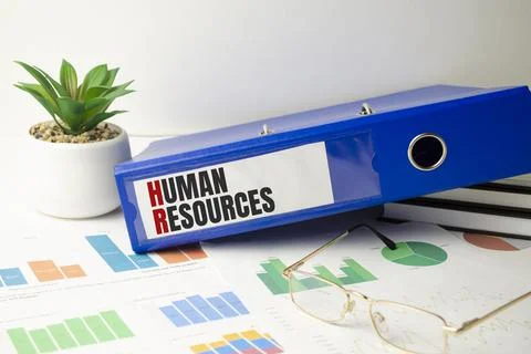 Human resources text written on folder with documents Stock Photos