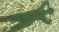 Human shadow experimental moving in low tide water HD Footage