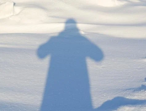 Human shadow on the snow Stock Photos