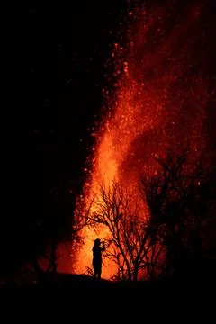 Human silhouette standing against exploding lava in La Palma Canary Islands 2 Stockfoto's