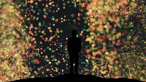 The human silhouette standing on a magic flying particles background Stock Footage 165354075