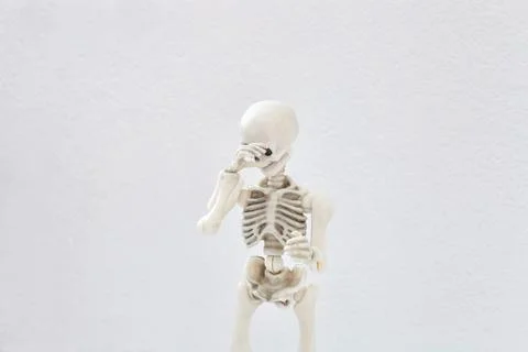 Human skeleton covers his face with his hand, shy and shame concept Stock-Fotos