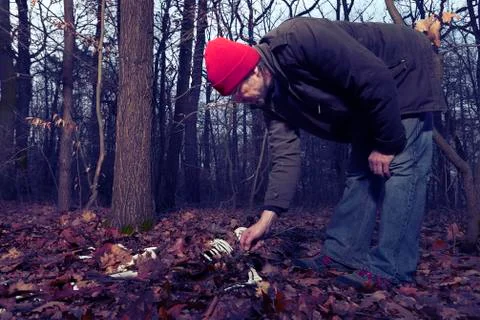 Human skeleton found in winter forest by couple of man Stock Photos