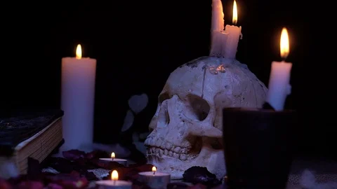 The human skull and the ancient book, the magic rite Stock Footage 86433644