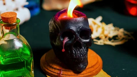Human skull candle selective focus, arranged with black candles and spell p.. Stock Footage 314614037