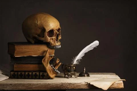 Human Skull on old Books with empty Page, Feather and Inkpot Stock Photos