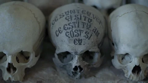 Human skulls with inscriptions in Mount Athos ossuary Stock Footage 330196341