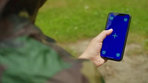 Human with smartphone green screen in the forest. Forester using cellphone with Stock Footage 257014503