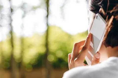 A human is talking to somebody while walking. Stock Photos