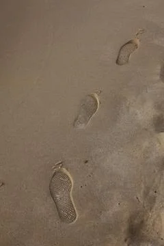 Human trace of on yellow sand Stock Photos