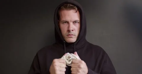 Human trafficking concept. Stop violence against Women. Maniac man holding rope Stock Footage 257293927