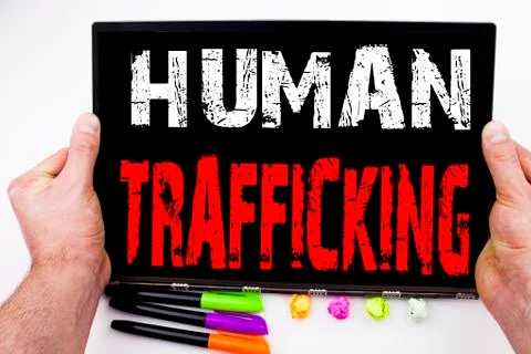 Human Trafficking text written on tablet, computer in the office with marker, Stock Photos