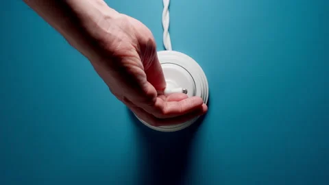 Human Turning On The Toggle Switch With A Wire On Blue Wall Vídeo Stock 146678158