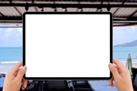Human two hands holding white tablet computer white screen mockup at beach re Stock Illustration
