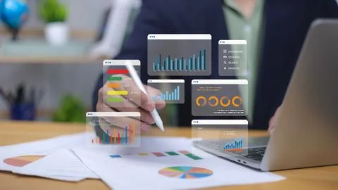 Human uses pen interacting with digital business analytics and reports. Sym.. Stockfoto's