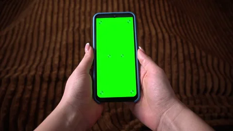 Human Uses a Smartphone with a Green Screen with a Chromatic Key Stock Footage 265141420