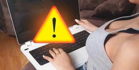 Human using Laptop computer. System hacked warning alert Stock Photos