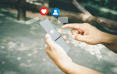 A human using a smartphone with Social media. The concept of living on vacati Stock Photos