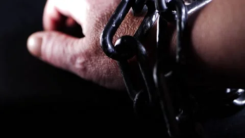 Human wrist in heavy chains Stock Footage 169857988