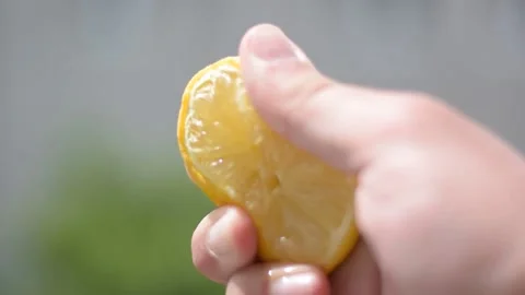 Humand hand squeezing lemon Stock Footage