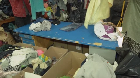 Humanitarian aid. old clothes. Clothes pile for poor people. secondhand. Stock Footage 86532397