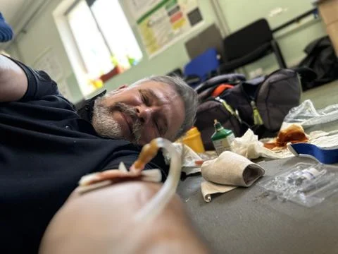 Humanitarian Paramedic Training Emergency Simulation with IV Treatment Indoors Stock Photos