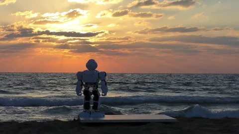 Humanoid autonomous smart Robot looks at beautiful sunset after hard day at work Видео 79511539
