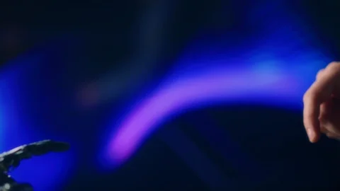 Humanoid Robot Arm Touches Human Hand. Humanity and Artificial Intelligence Stock Footage 123633402