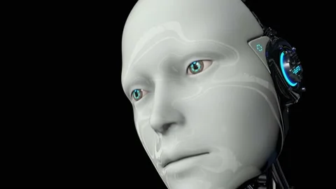 A humanoid robot on a black background turns on and raises its head. The camera Stock Footage 134069582
