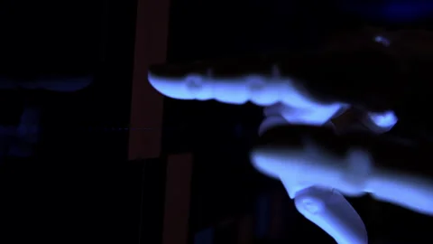 Humanoid robot hand analyzing economic charts from a computer screen Stock Footage 337962517