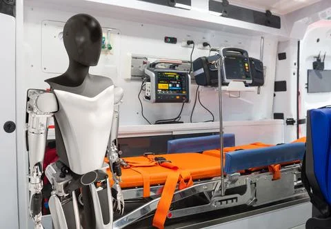 Humanoid robot inside modern emergency medical ambulance Stock Photos