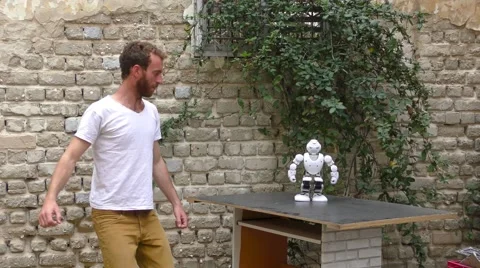 A humanoid robot teaches a young man to Stock Video Pond5