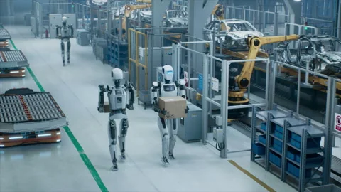 Humanoid Robot Transporting Box at Car Factory Stock Footage 320874701