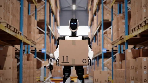 Humanoid robot worker walking with cardboard box in automated warehouse Stock Footage 329177853